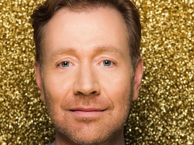 Tom Erik Lie, opera singer, close-up portrait against a sparkling gold glitter background